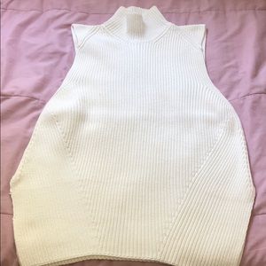 White turtle neck sleeve less sweater